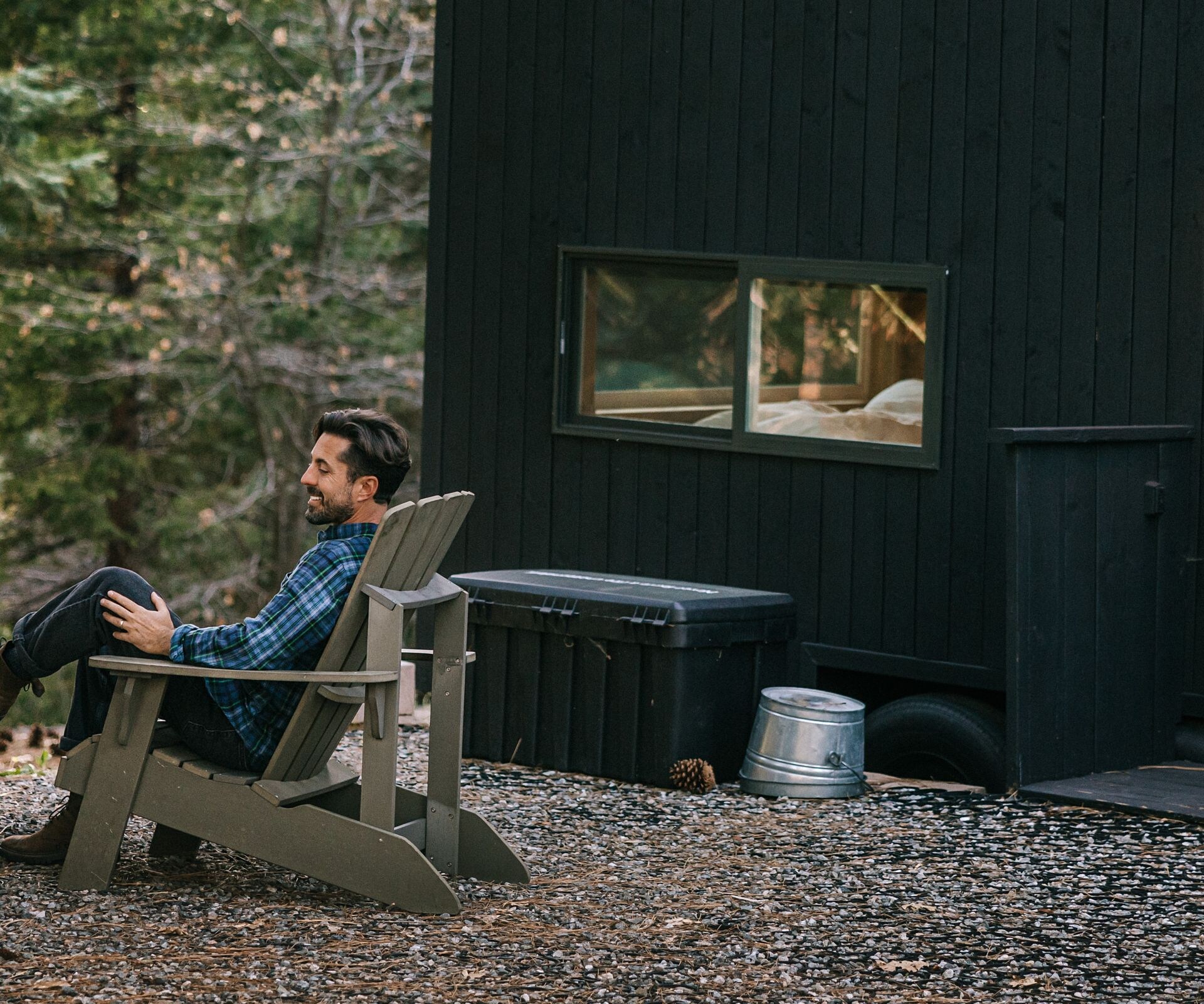 Outside view of cabin people around fire