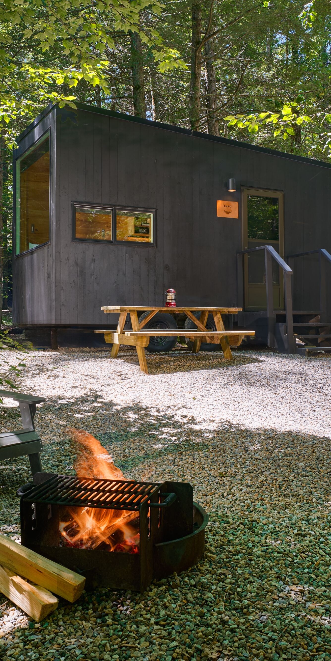 Cabin Exterior with Fire Pit and AdirondackChairs