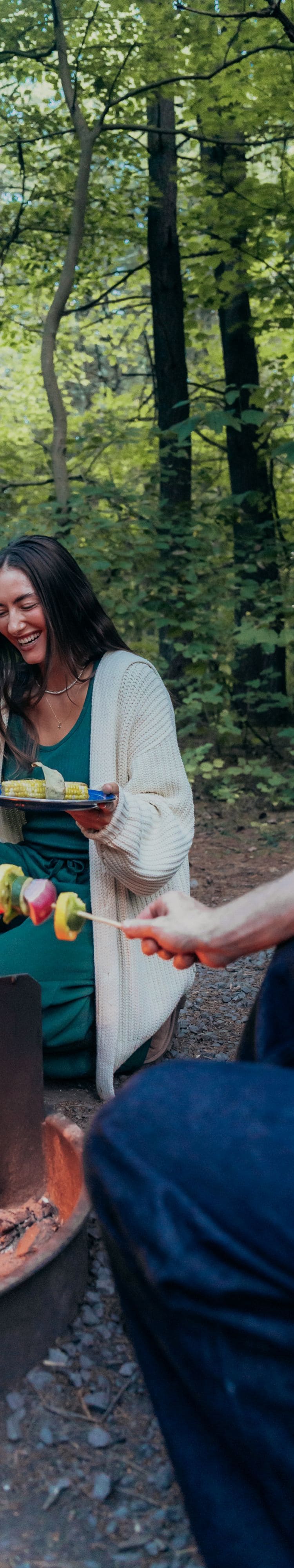 Couple cooking over fire pit