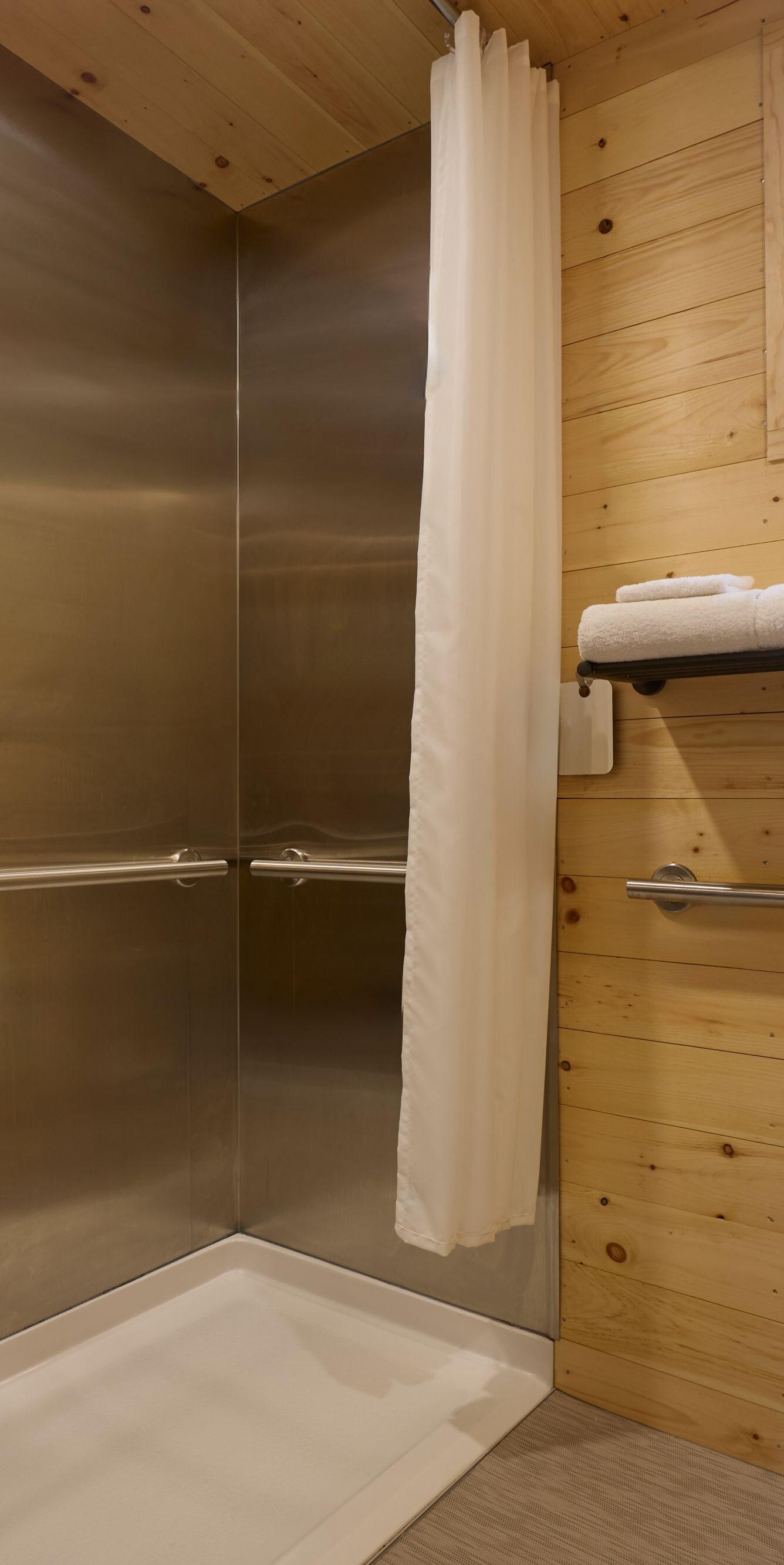Accessible roll-in shower with grab bars
