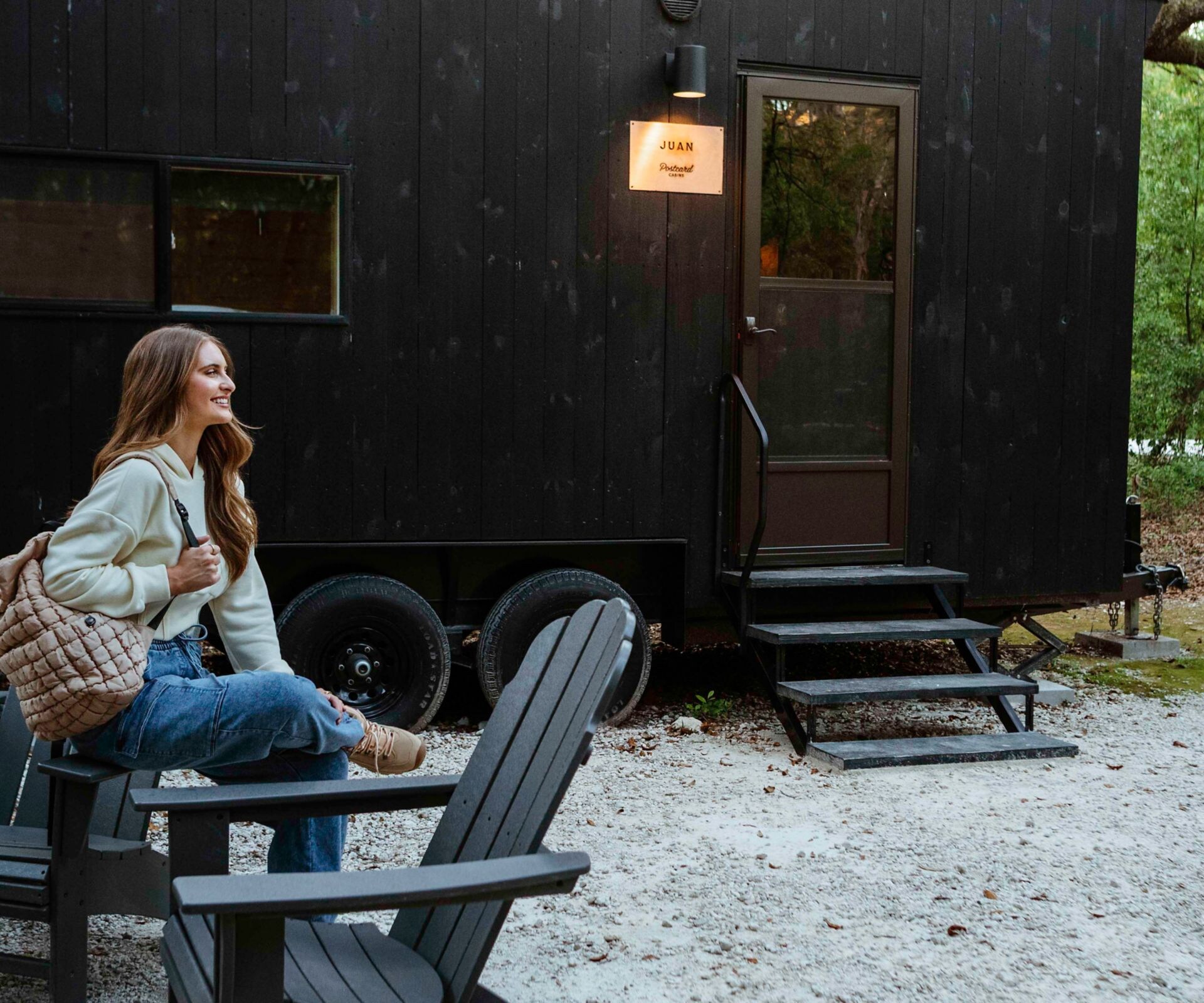woman sitting on chair outside cabin