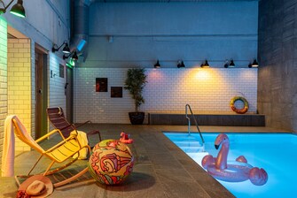 Indoor pool with chairs and beachball