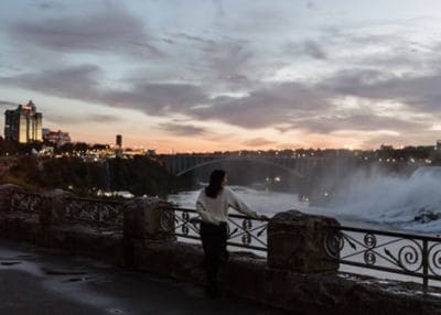 A woman overlooking the Canadian Niagara Falls.