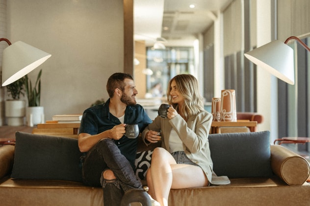 A couple enjoying a cup of coffee in a hotel lobby