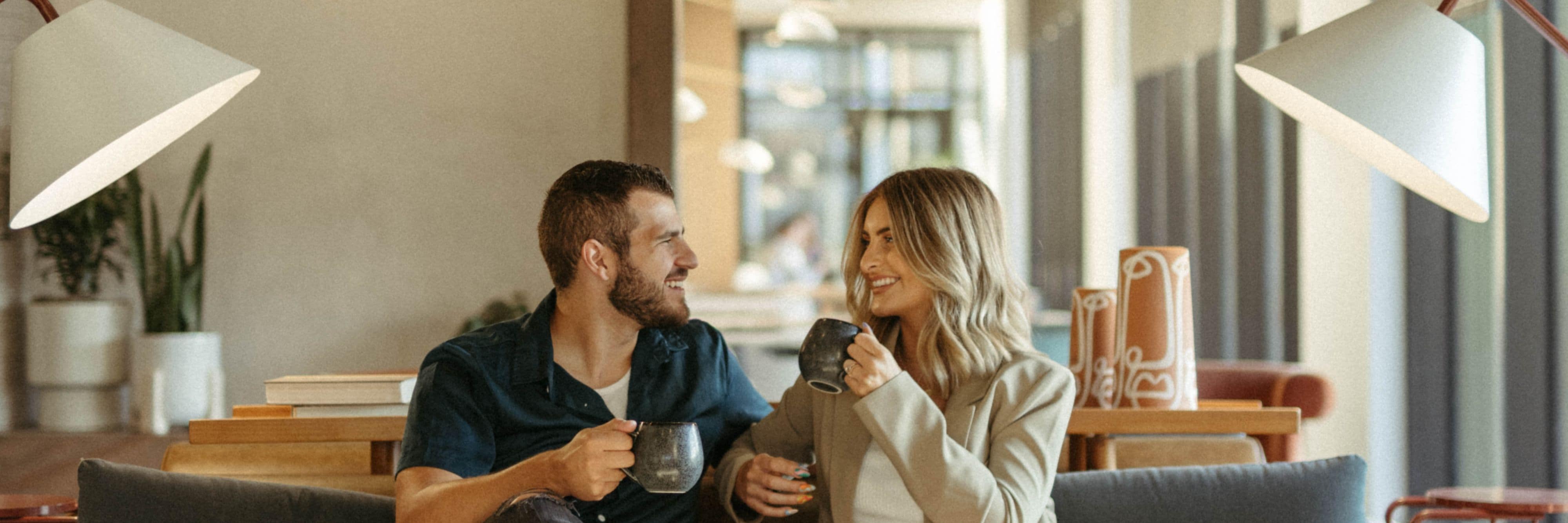 A couple enjoying a cup of coffee in a hotel lobby