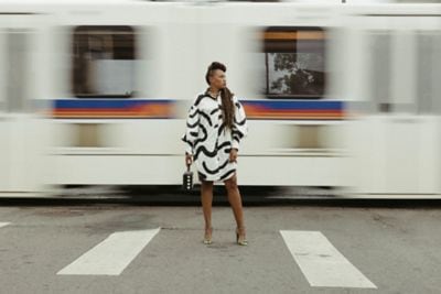 Denver woman stand in street crosswalk train bus