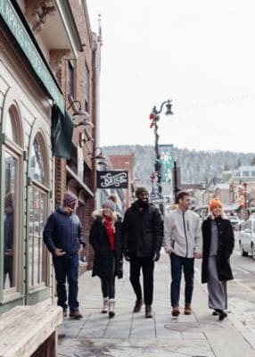Friends walking downtown Park City in the winter