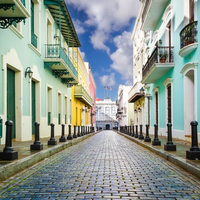 A cobblestone street between colorful buildings