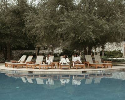 Three friends poolside at a resort in San Antonio