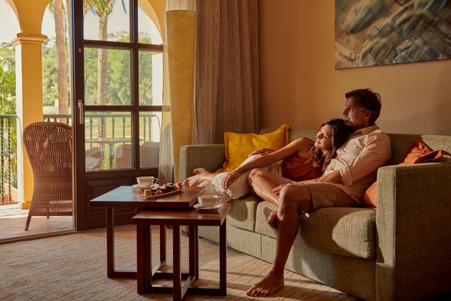 Couple Relaxing At Their Living Room