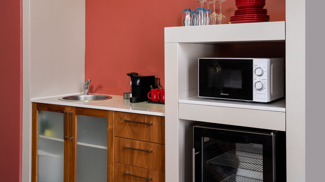 Kitchenette with microwave, oven, and sink