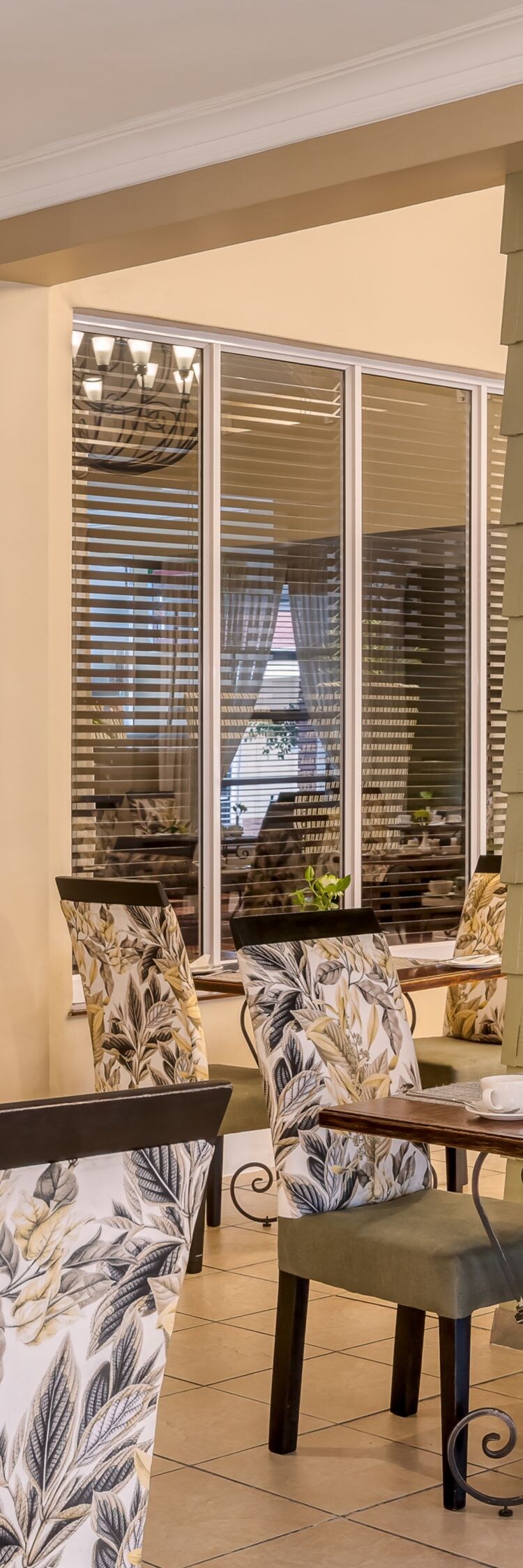 wood tables, floral print chairs in a dining area 