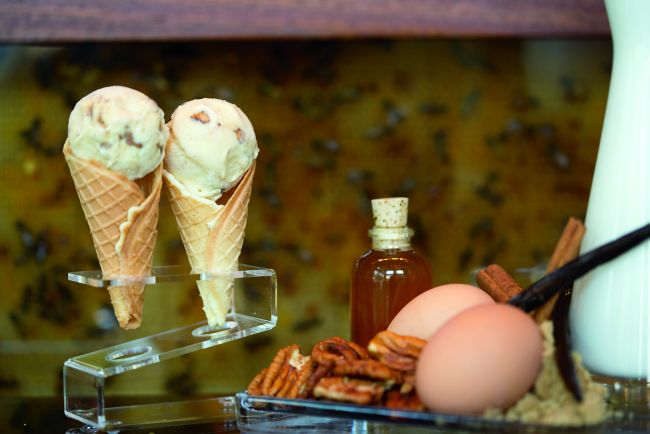 Twin scoops of honey-pecan ice cream rest inside waffle cones