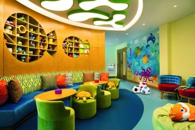 Playroom featuring an aquatic theme with shelving shaped like fish, a mural and colorful seating
