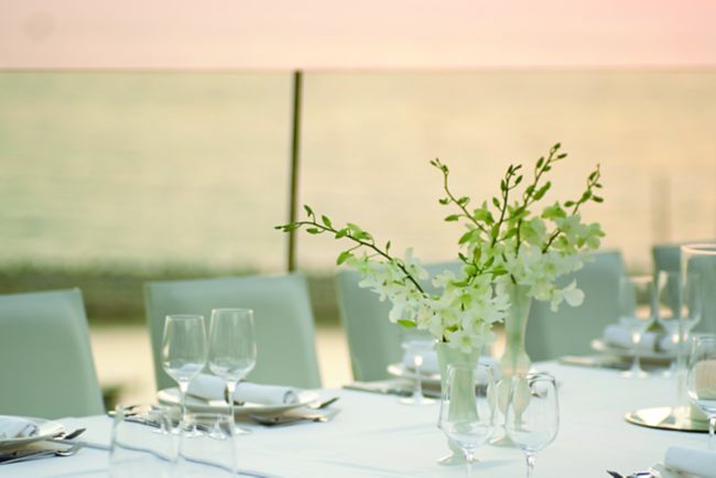 Wedding table in white on a rooftop venue at sunset
