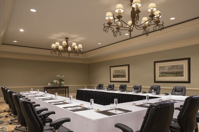U-shape setup in the Great Egret boardroom with black leather swivel chairs, black blotters and stationery