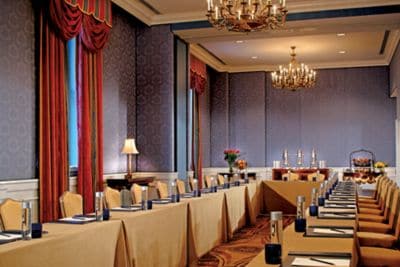 Custom blue silk upholstered walls complement the historic building?s meeting space in the Pavilion Ballroom