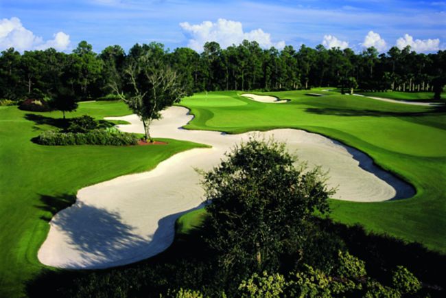 Trees hem in rolling greens and a vast sand trap at The Ritz-Carlton Members Golf Club in Sarasota