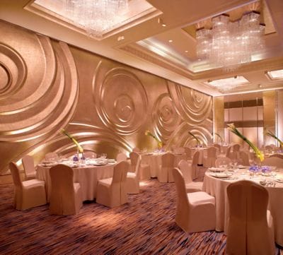 Ballroom set for formal dinner with round tables and chairs