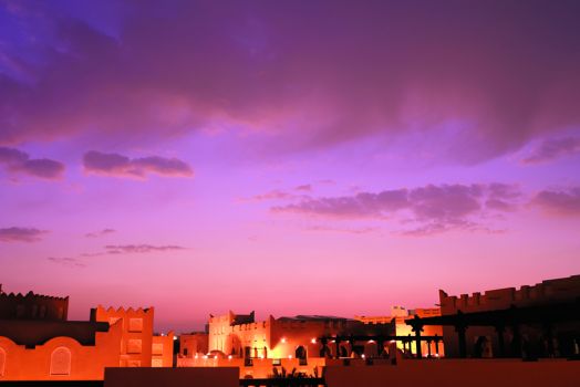 Colorful sky with large building complex below
