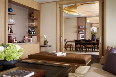 Soft-contemporary living room and wet bar with pocket doors open to the dining room