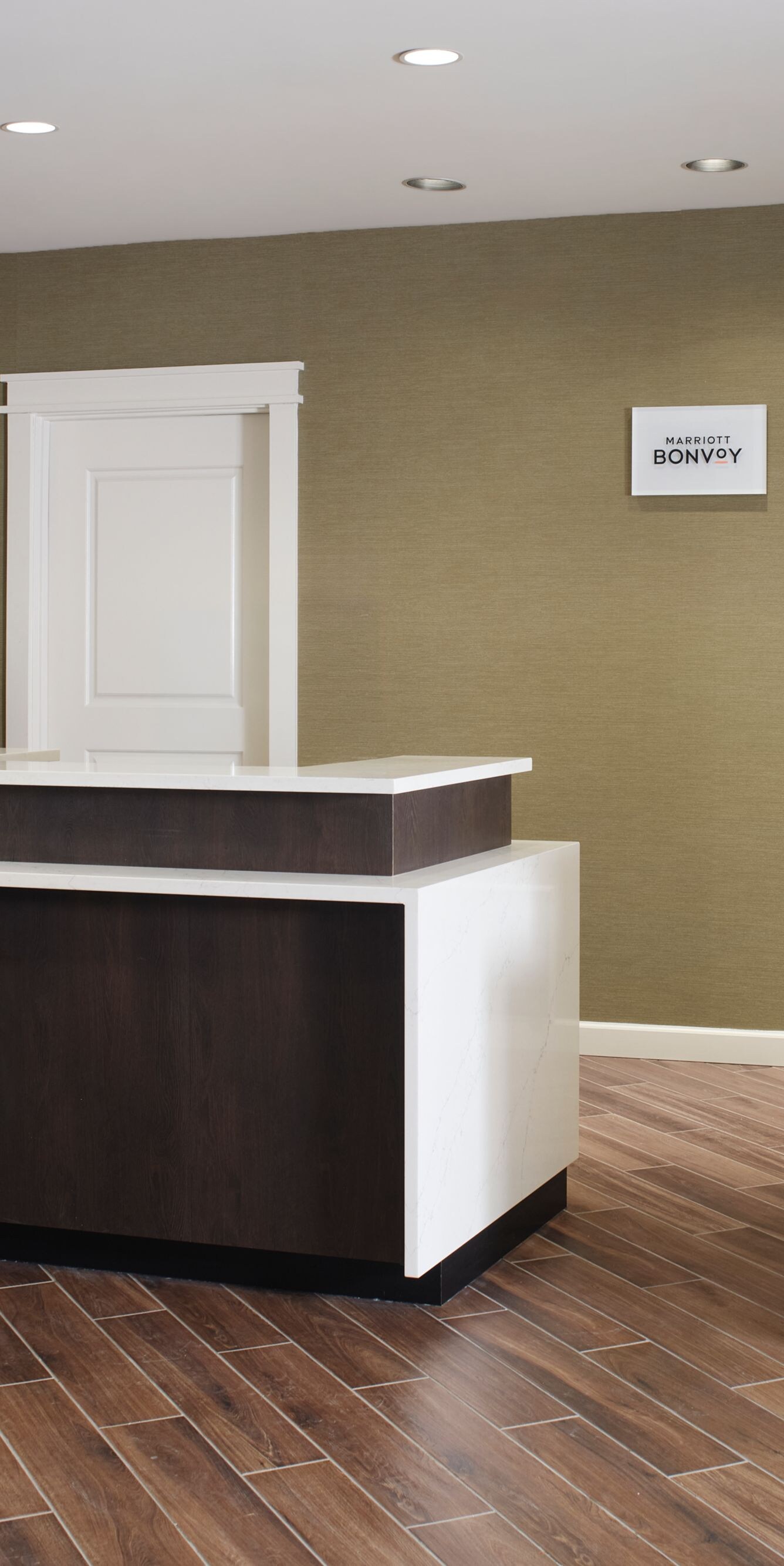 Hotel front desk with wood counters and tile floor