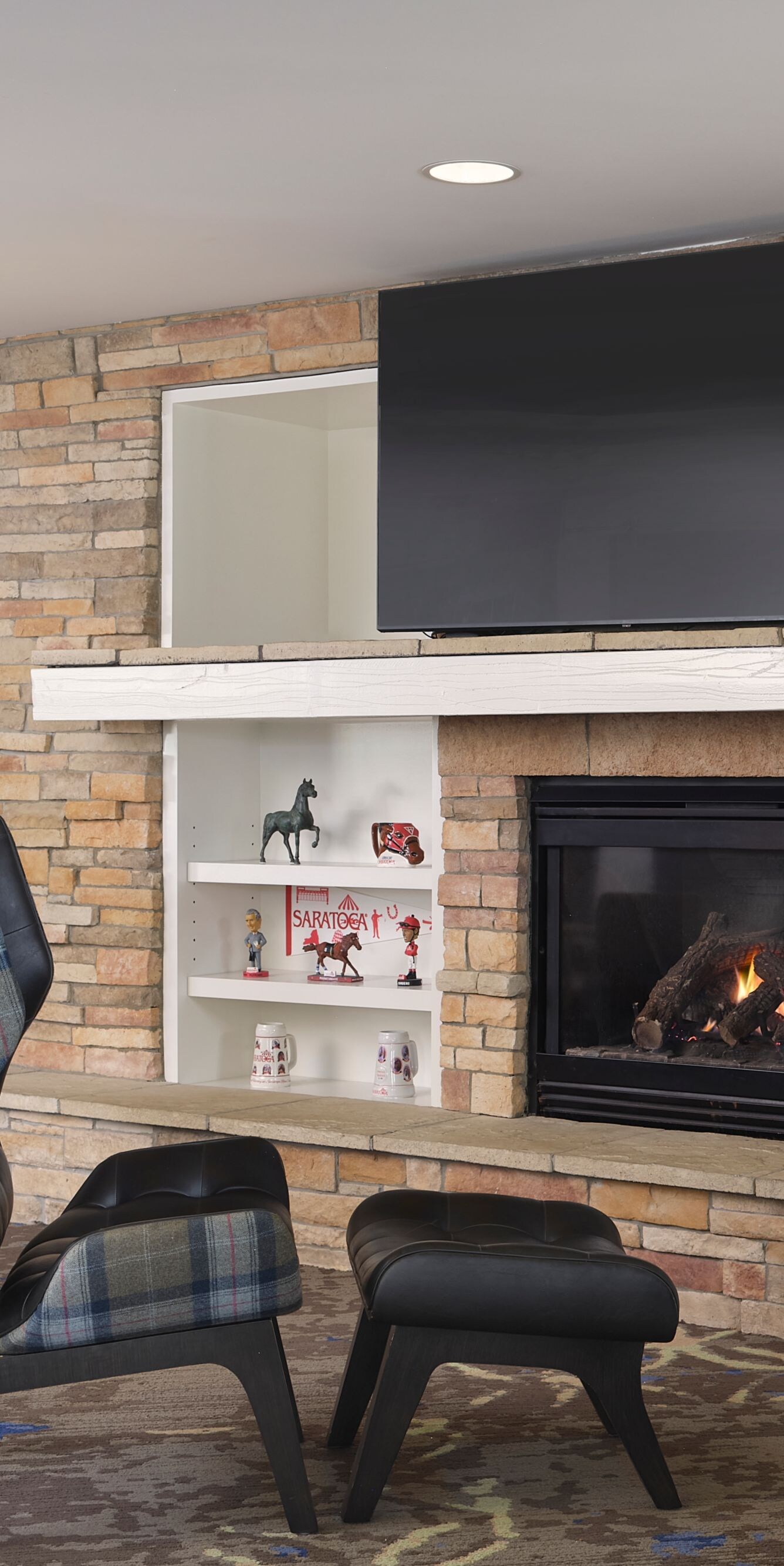 Lounge area with fireplace, TV, and chairs