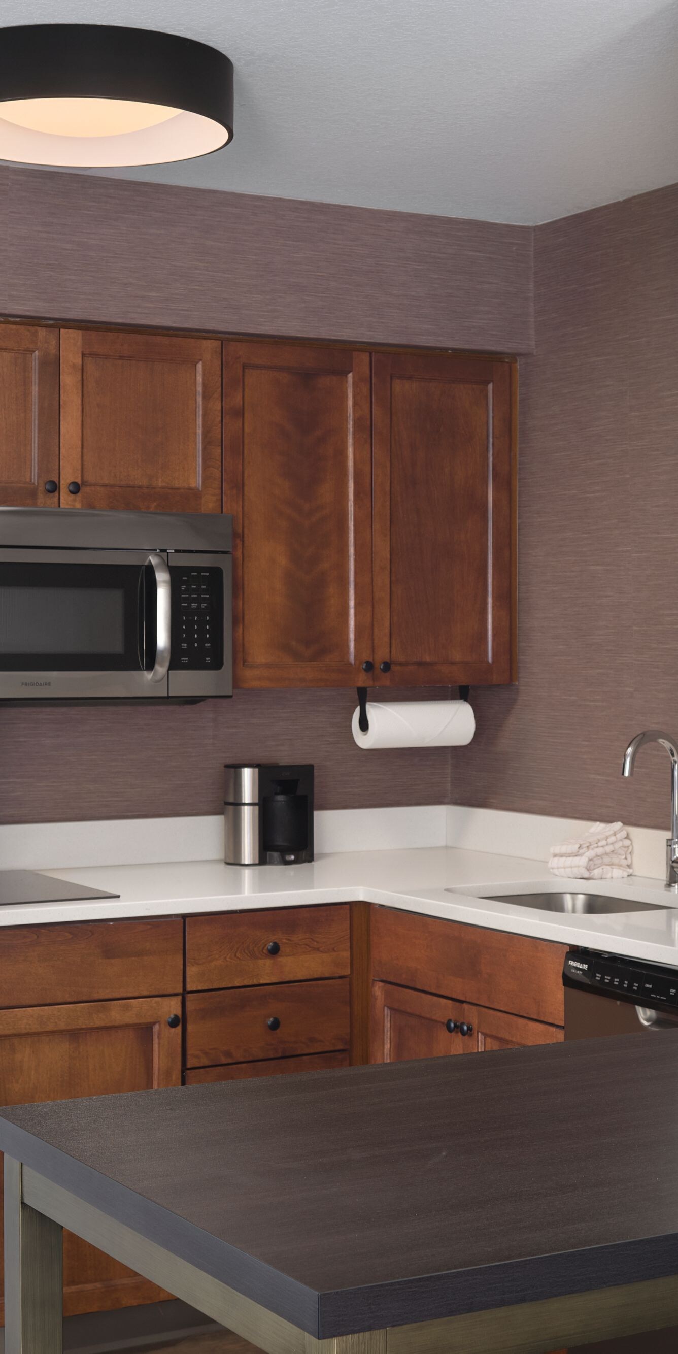 Full kitchen with a cooktop stove, utensils