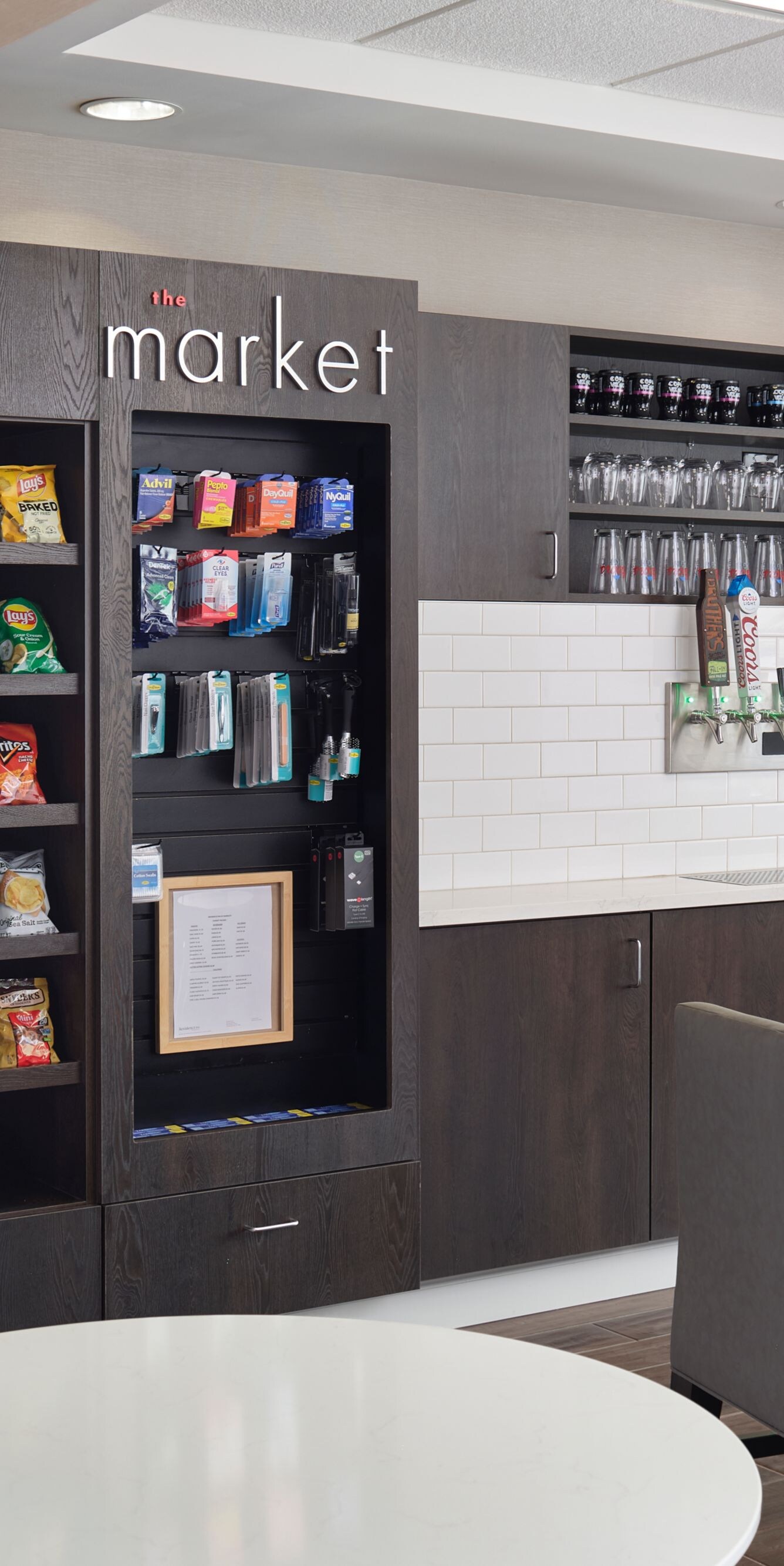 Market area with snack shelves and drink coolers