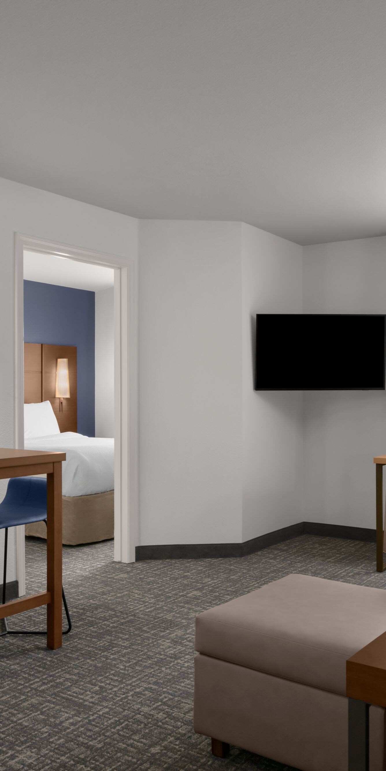 Suite living area with couch, desk and table