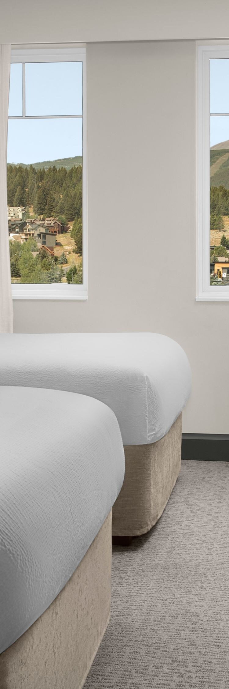 two beds, tv, and a view