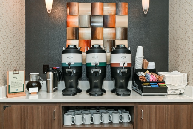 coffee urns, coffee cups, sugar, and milk.