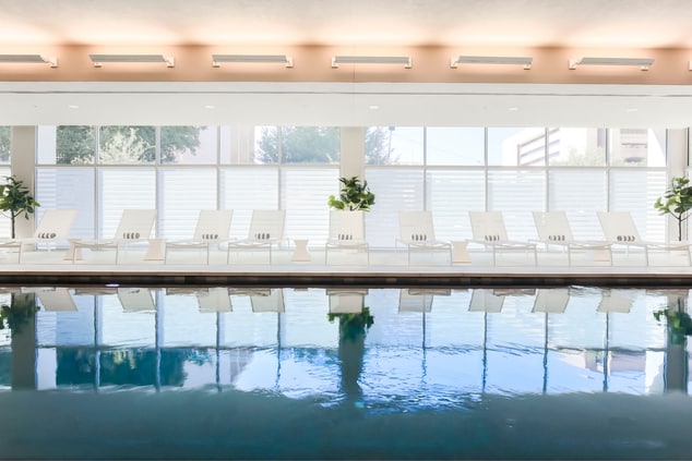 Deck chairs lined up on indoor pool deck