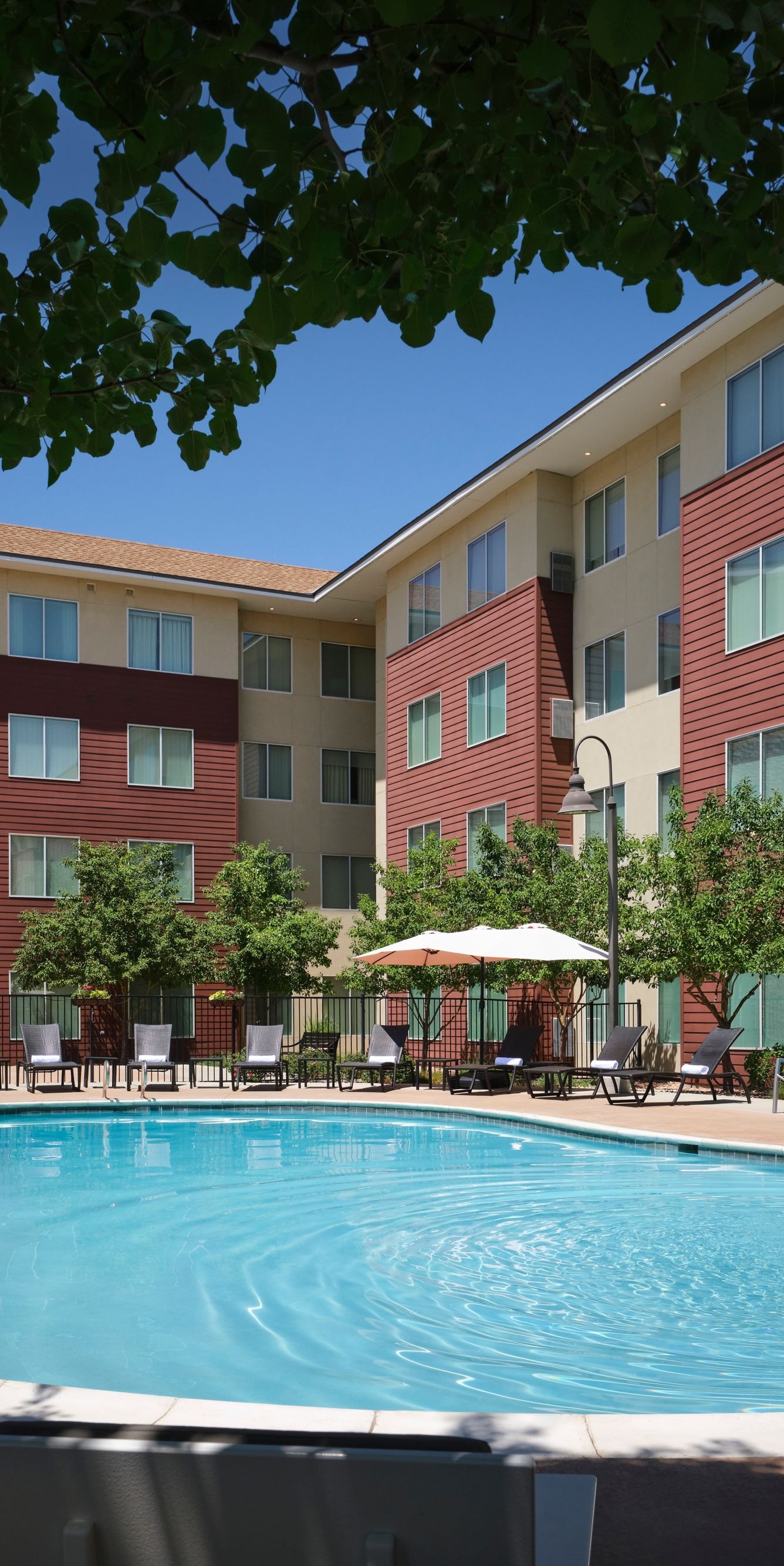 Pool with lounge chairs and umbrellas