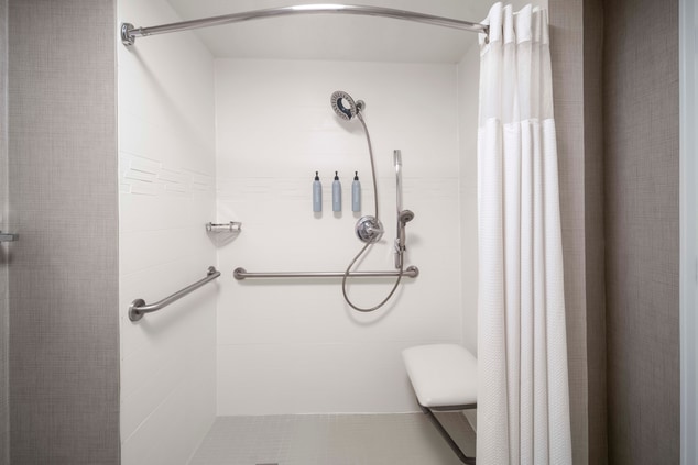 Roll-in shower with chair and grab bars