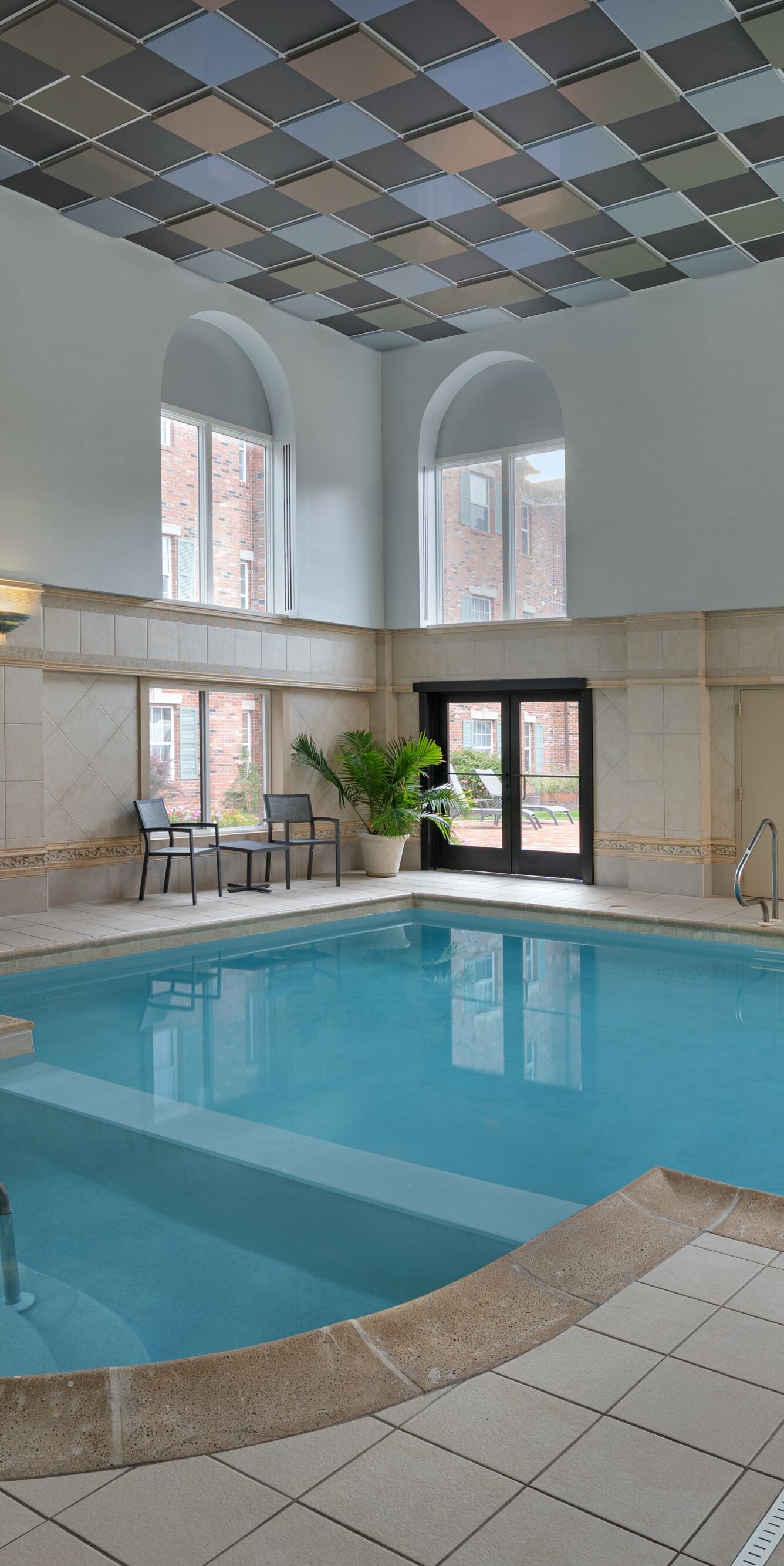 Indoor pool with side seating on property