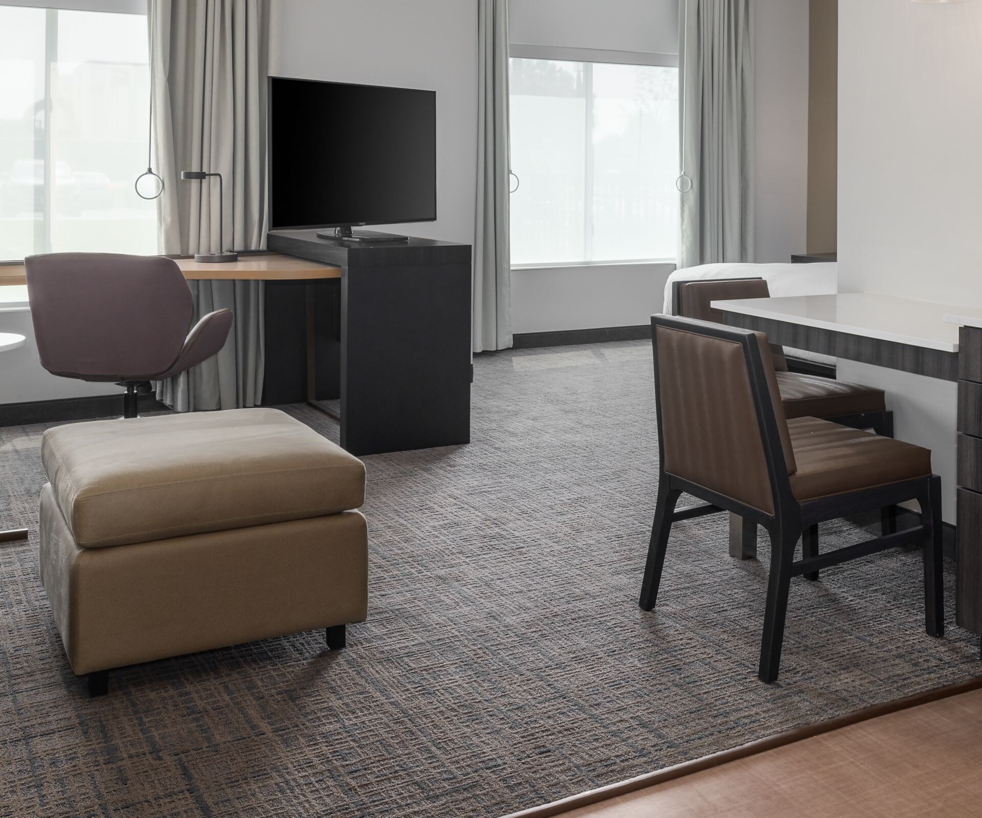 Accessible suite living area with sofa, TV