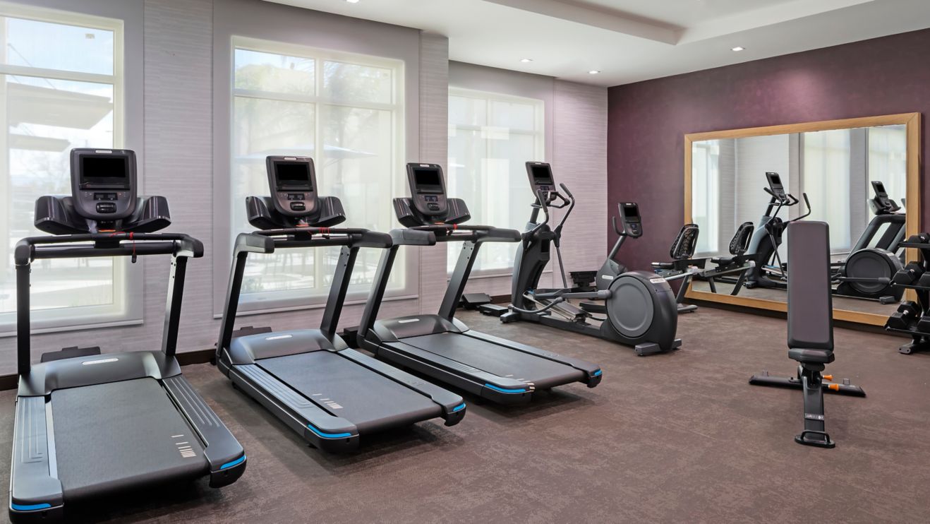 Fitness center with various cardio equipment. 