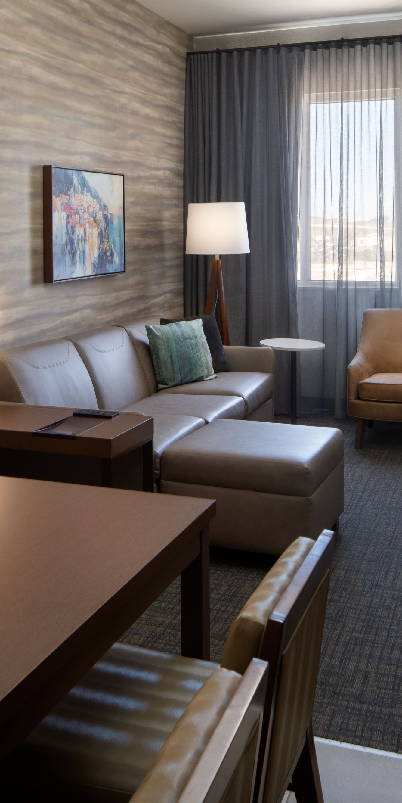 Suite living area with sofa and desk