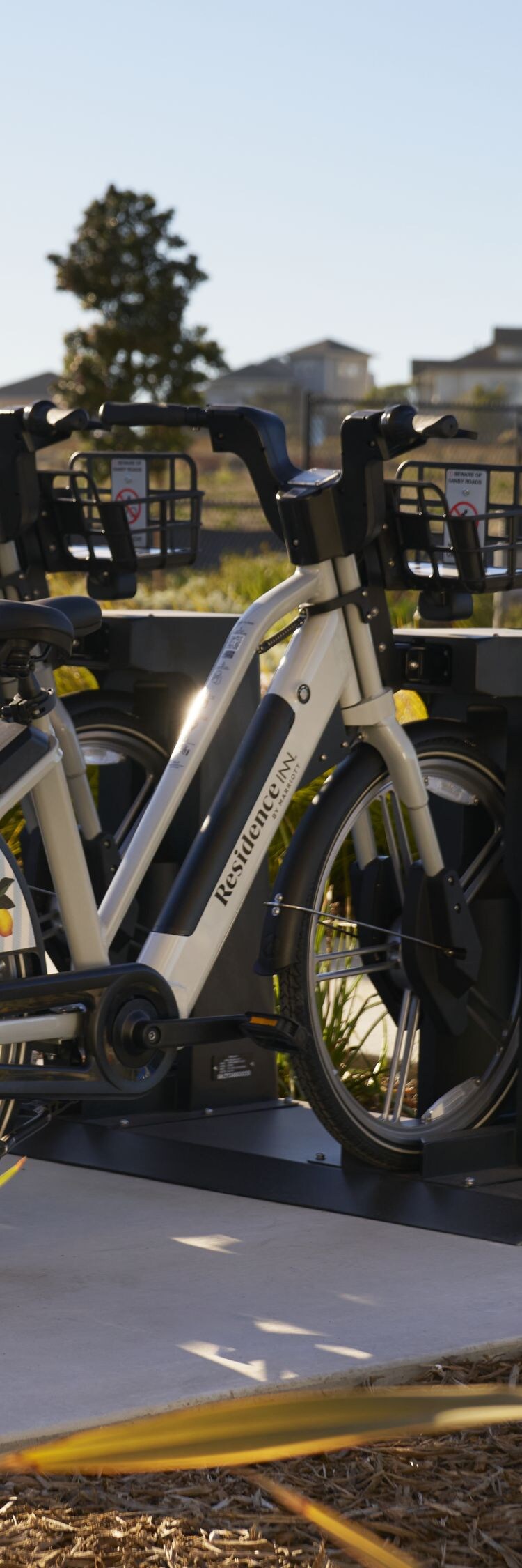 Row of electric bikes parked at a docking station