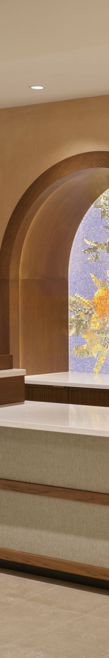 front desk with three counters and arched mosaics