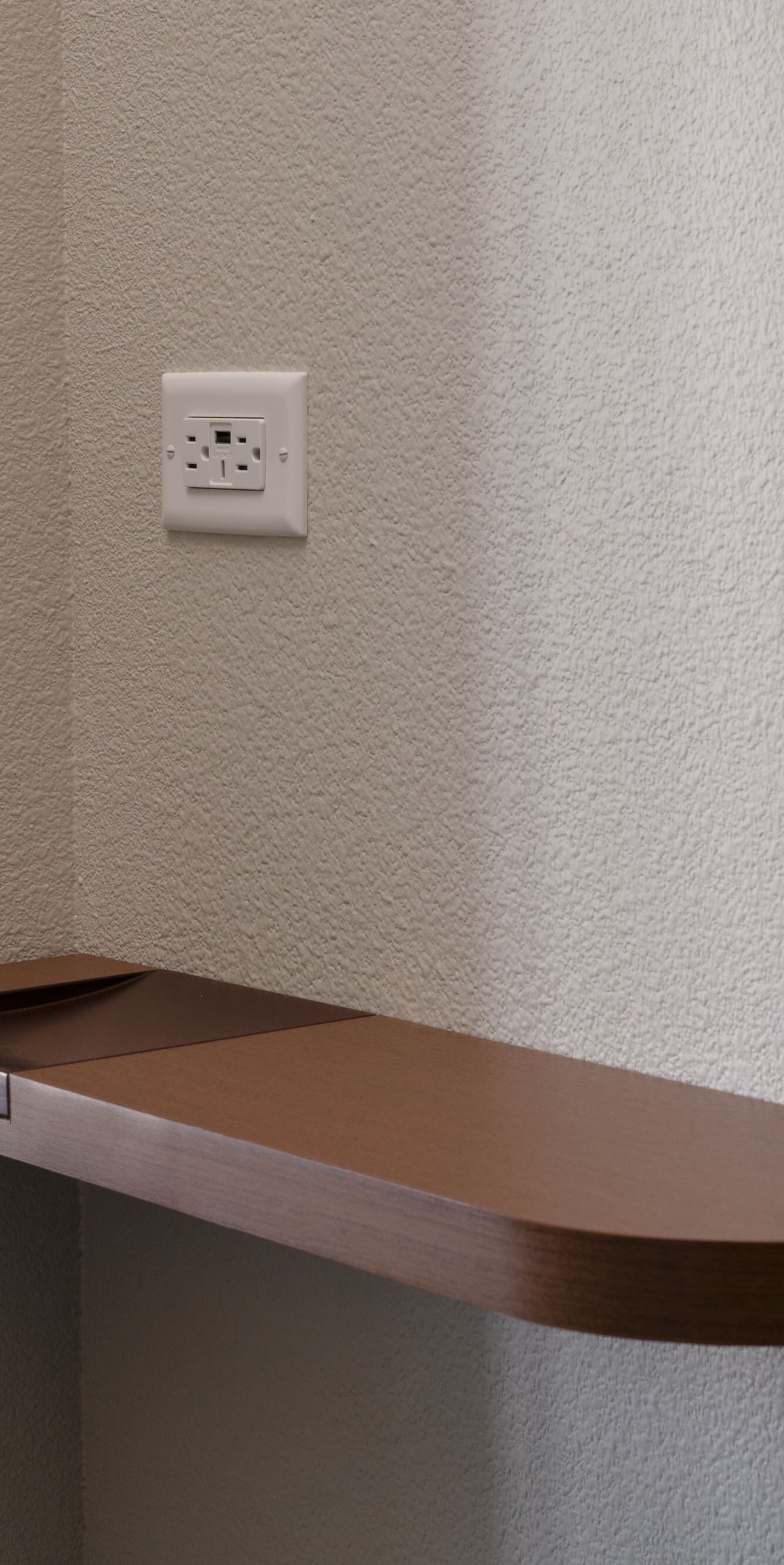 Guest room wall shelf with power outlet