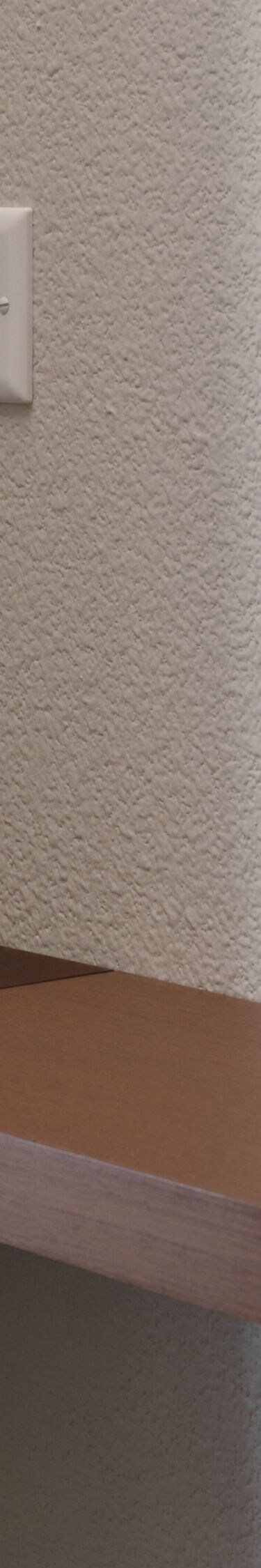 Guest room wall shelf with power outlet