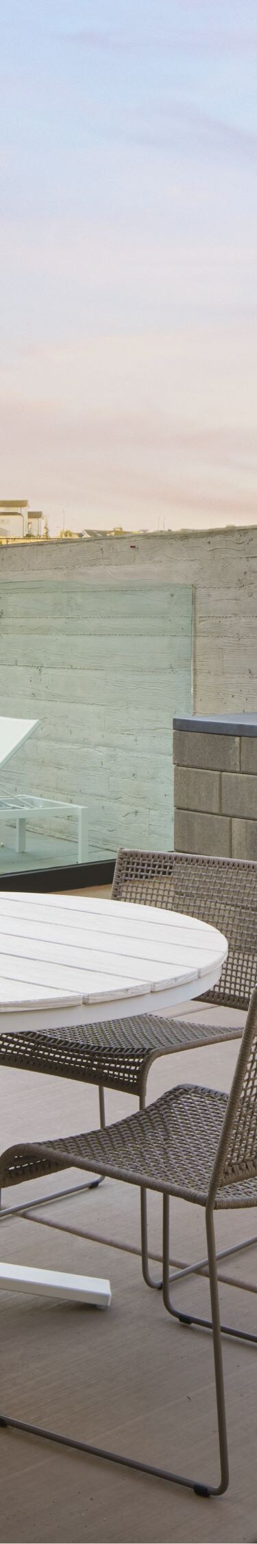 table and chairs on a patio with grills