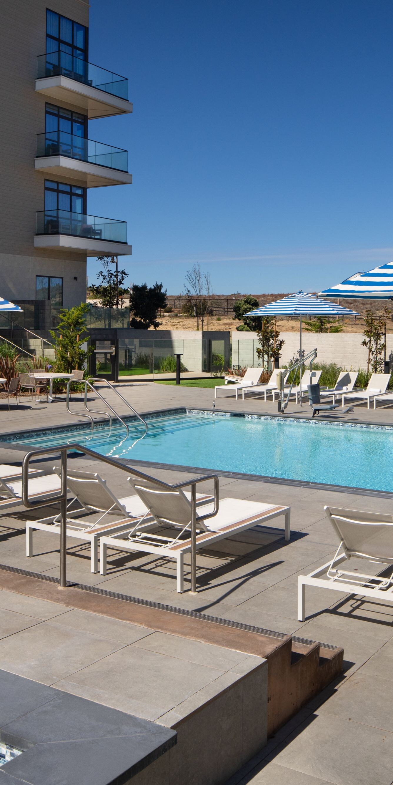 Outdoor pool with lounge chairs and umbrellas
