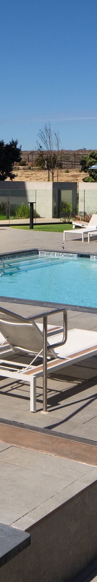 Outdoor pool with lounge chairs and umbrellas