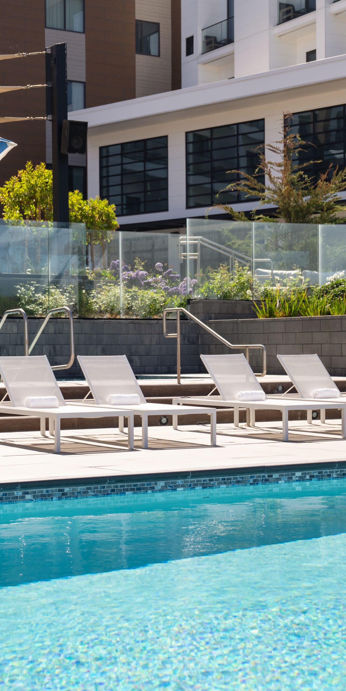 Outdoor pool with lounge chairs and umbrellas