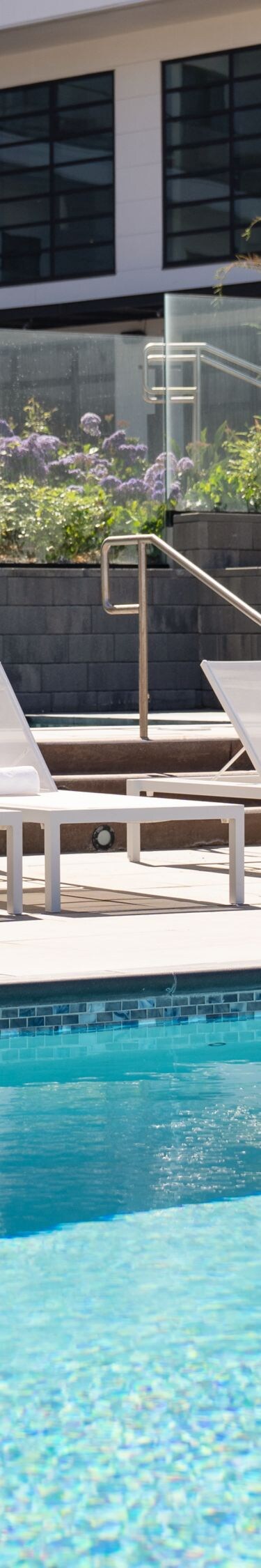 Outdoor pool with lounge chairs and umbrellas