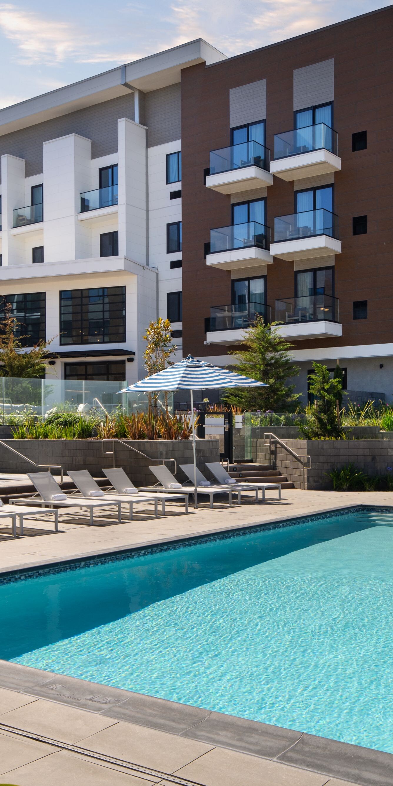 Outdoor pool with lounge chairs and building