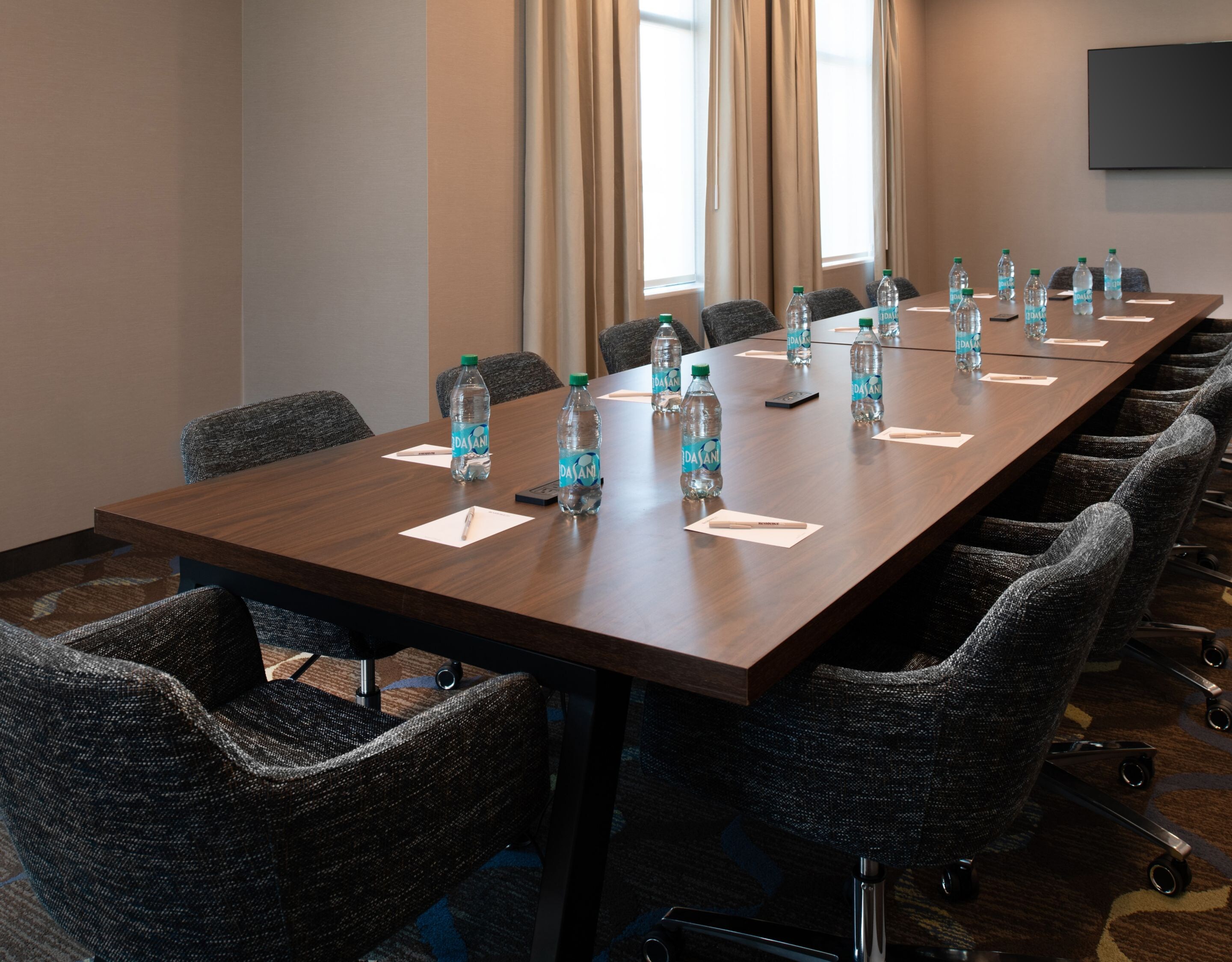 Boardroom has TV & includes water, pens & pads.